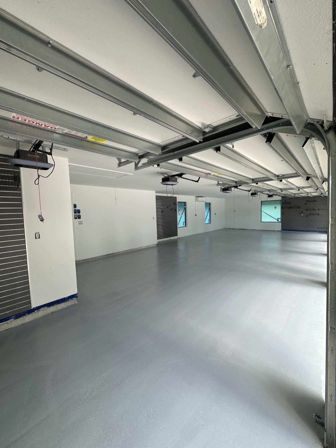 Four-car garage floor prepared for its metallic coating