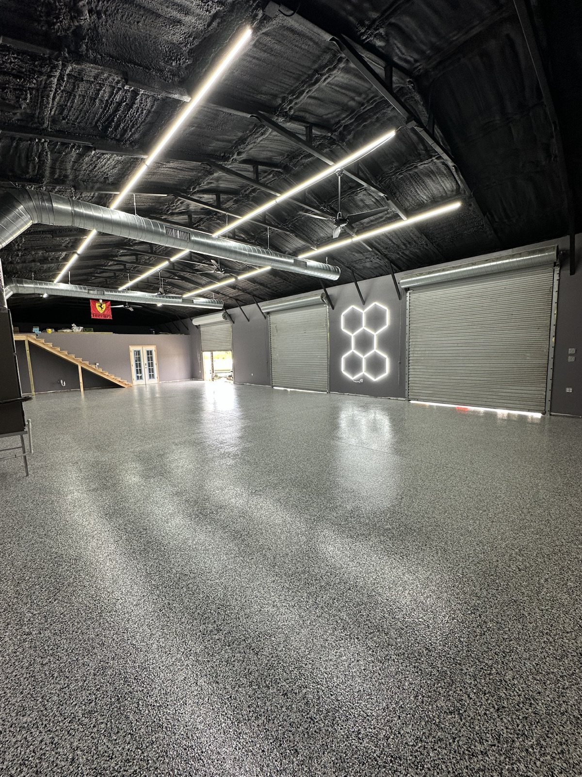Angled view of completed gray flake floor and garage bays